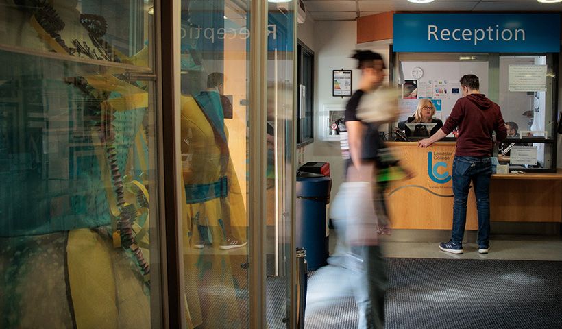 a person standing at reception